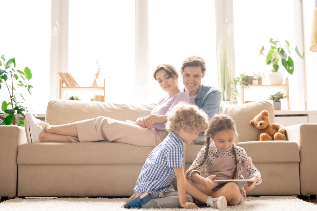 Family sitting in living room. 